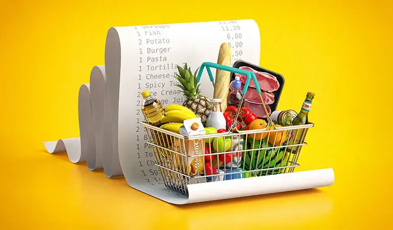 a shopping cart with food in it and a bill behind it